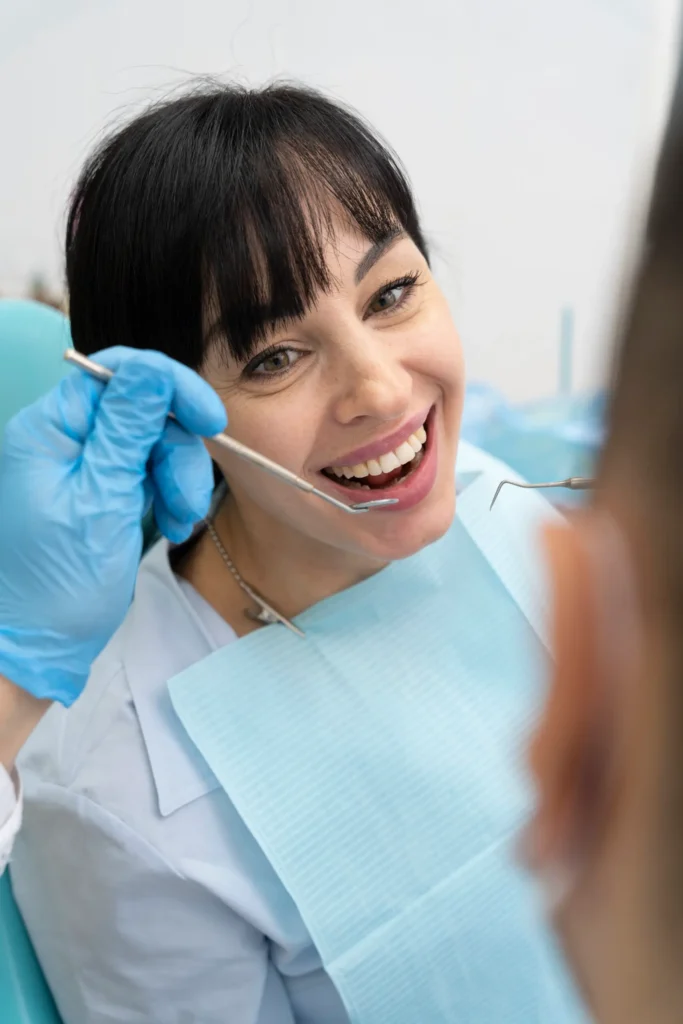 Dentist performing oral health evaluation on female patient for preventative dentistry in Chicago.