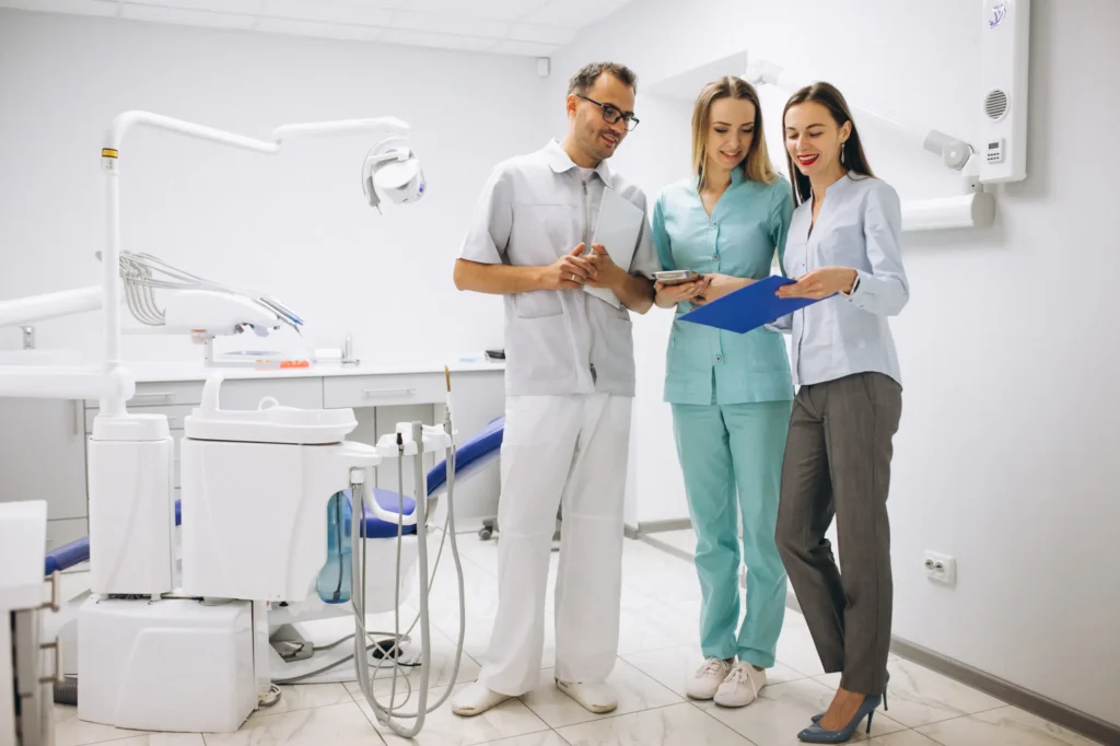 Dentists discussing patient results with a patient in an expert dental services consultation.