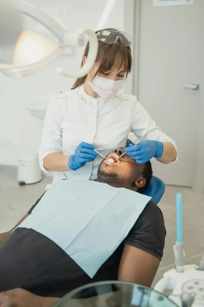 Male patient being examined by dentist for full mouth reconstruction in Chicago.