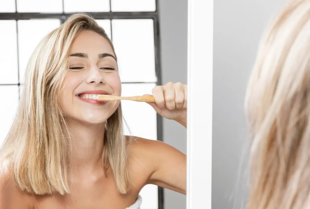 Brushing with fluoride toothpaste to remineralize teeth and restore enamel